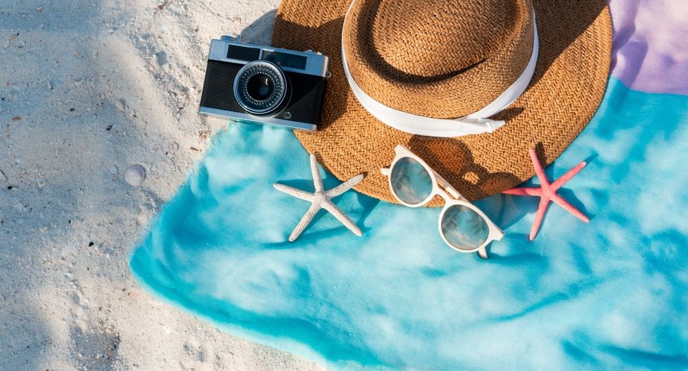 Top,View,Of,Summer,Items,On,Sand,At,The,Beach.